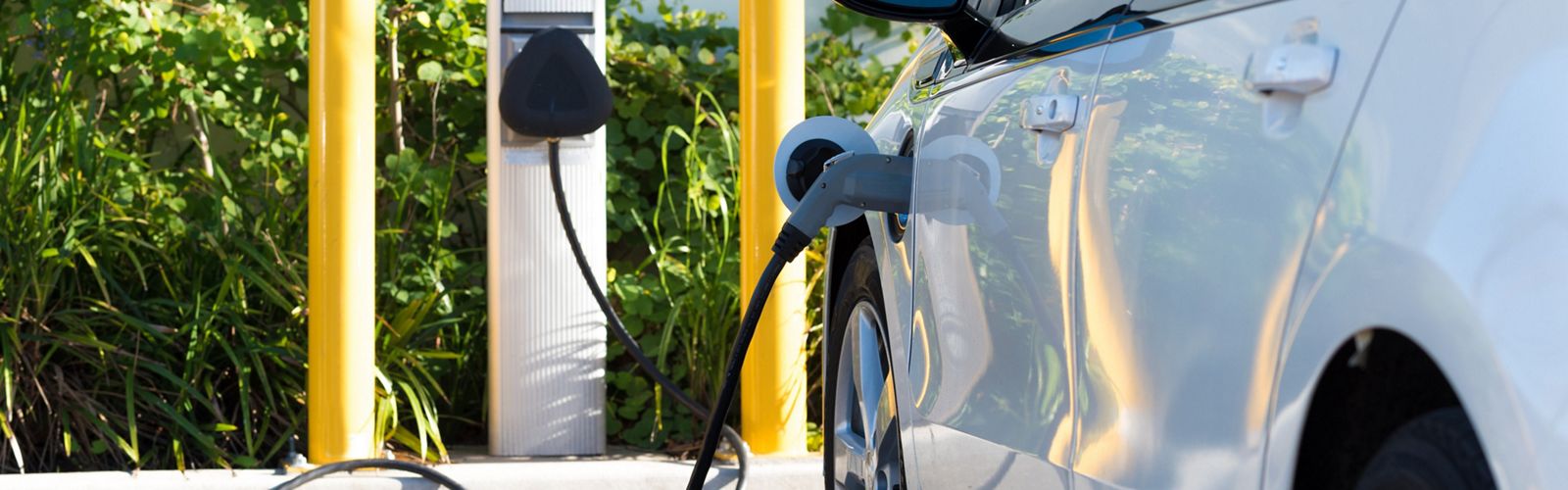 Photo of an electric vehicle at a charging station.