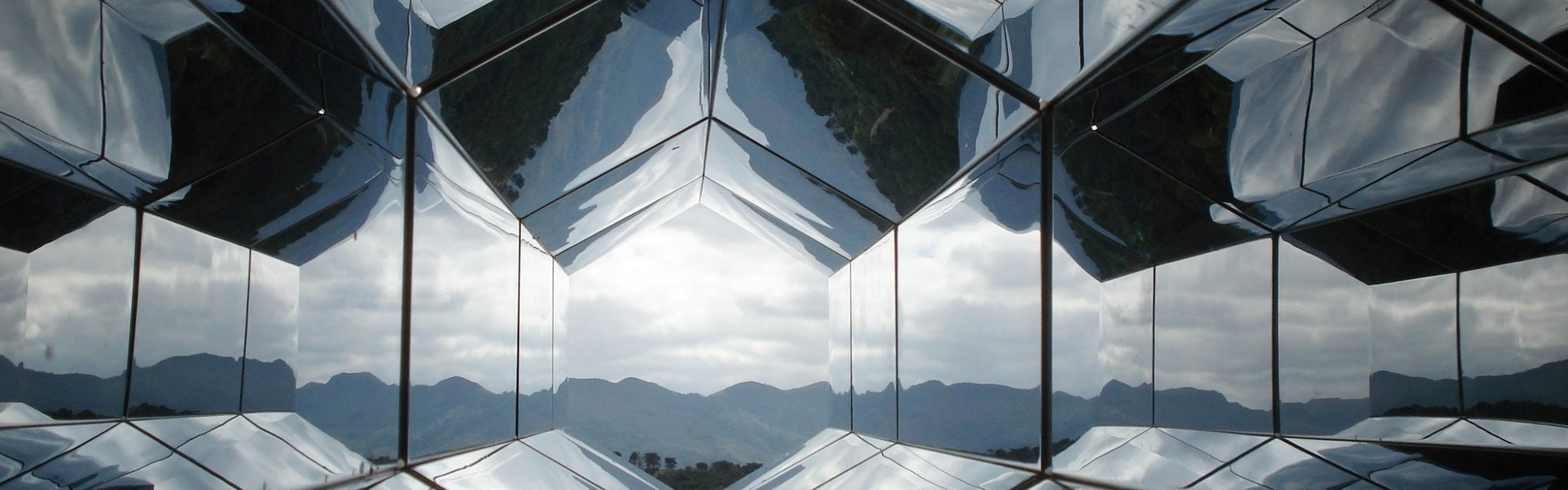 View looking up toward the tops of several glass skyscrapers.