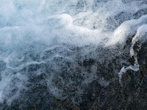 Fast moving water splashes in whitewater rapids.