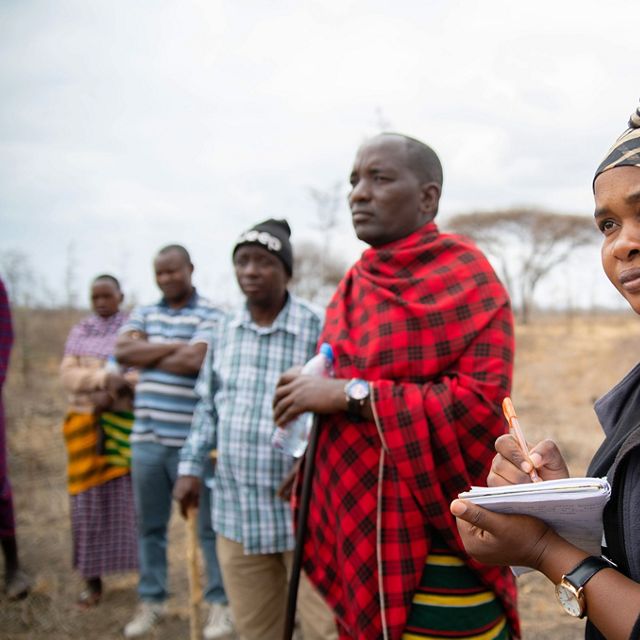 Warda Kanagwa stands with community members in Randilen Wildlife Management Area in Tanzania.