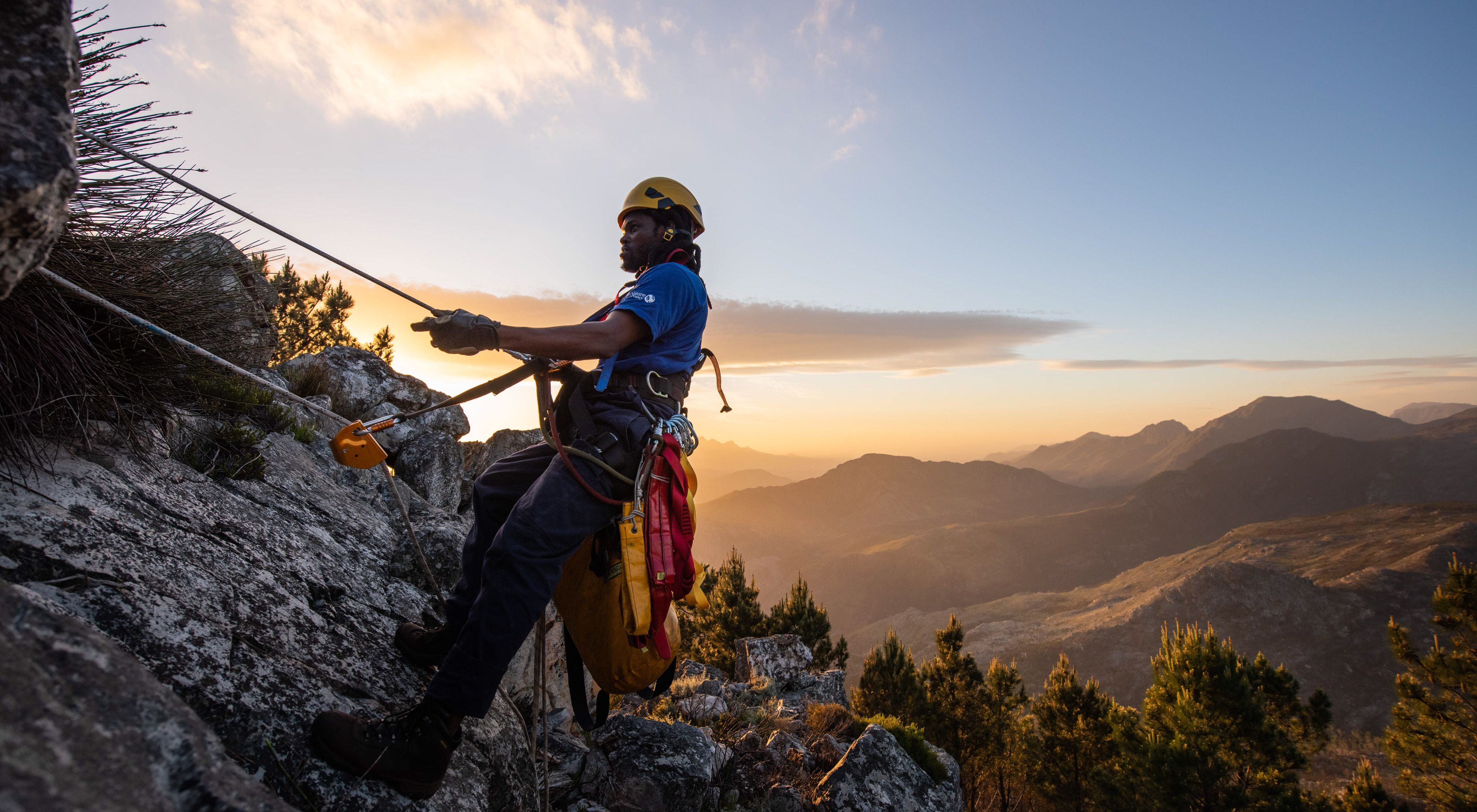 A professional climber climbing the side of a mountain