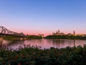 River in foreground with canadian parliament building in background.