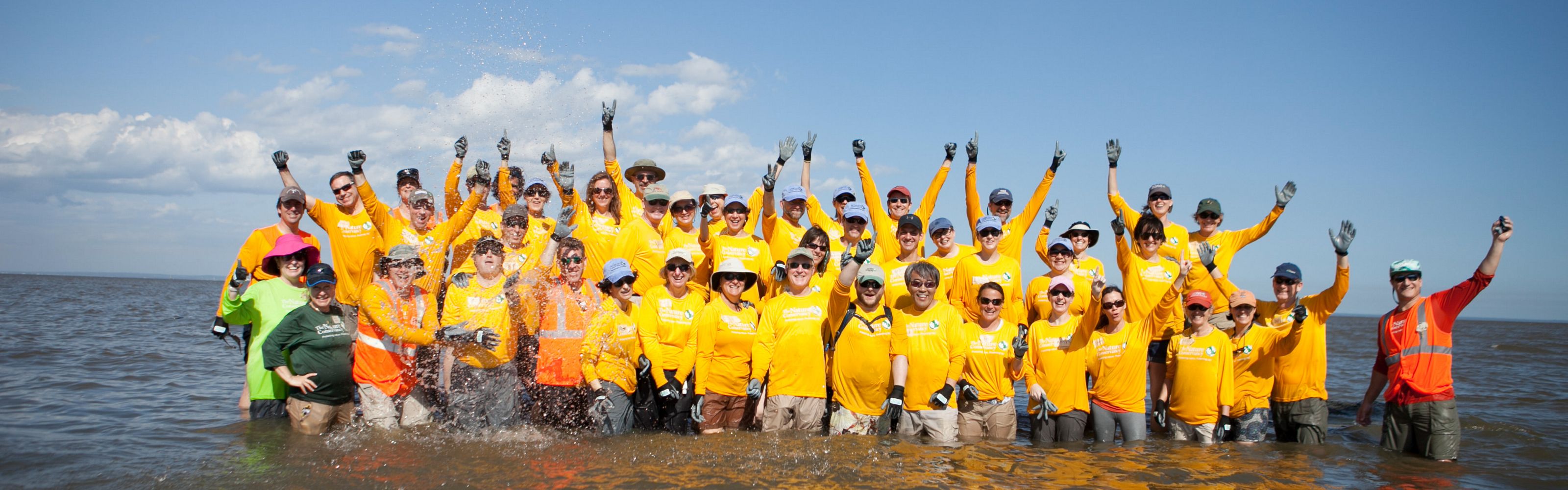 TNC Senior Leaders work together to build five reef structures at Arlington Cove in Mobile Bay, Alabama